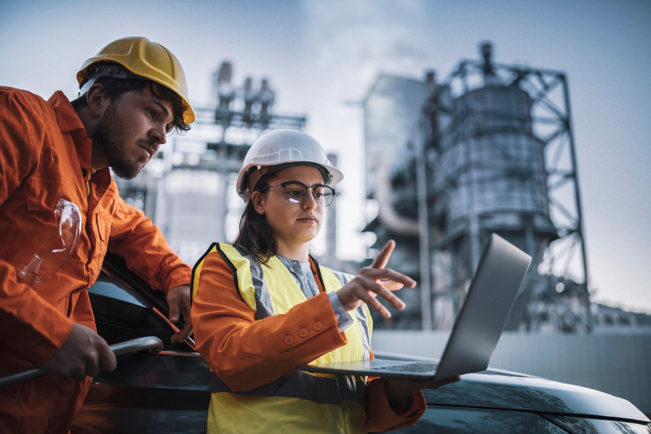 Female chartered engineer in high-visibility gear at an industrial facility